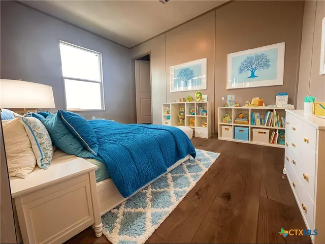 a bed sitting in a bedroom next to a window