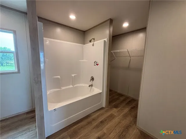 a bathroom with a bathtub and a shower