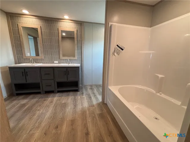 a bathroom with a bathtub and a sink