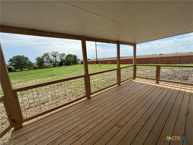 a view of balcony with wooden floor