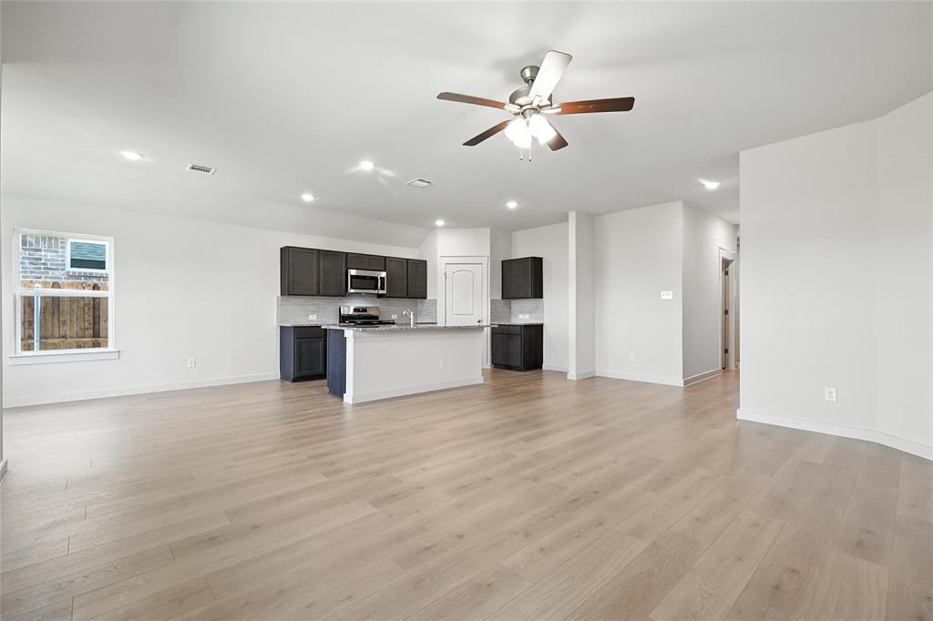 1795 Gleasondale Place Forney, TX 75126 - Photo 10 of 29 Unfurnished living room featuring a ceiling fan, light wood-style flooring, and recessed lighting