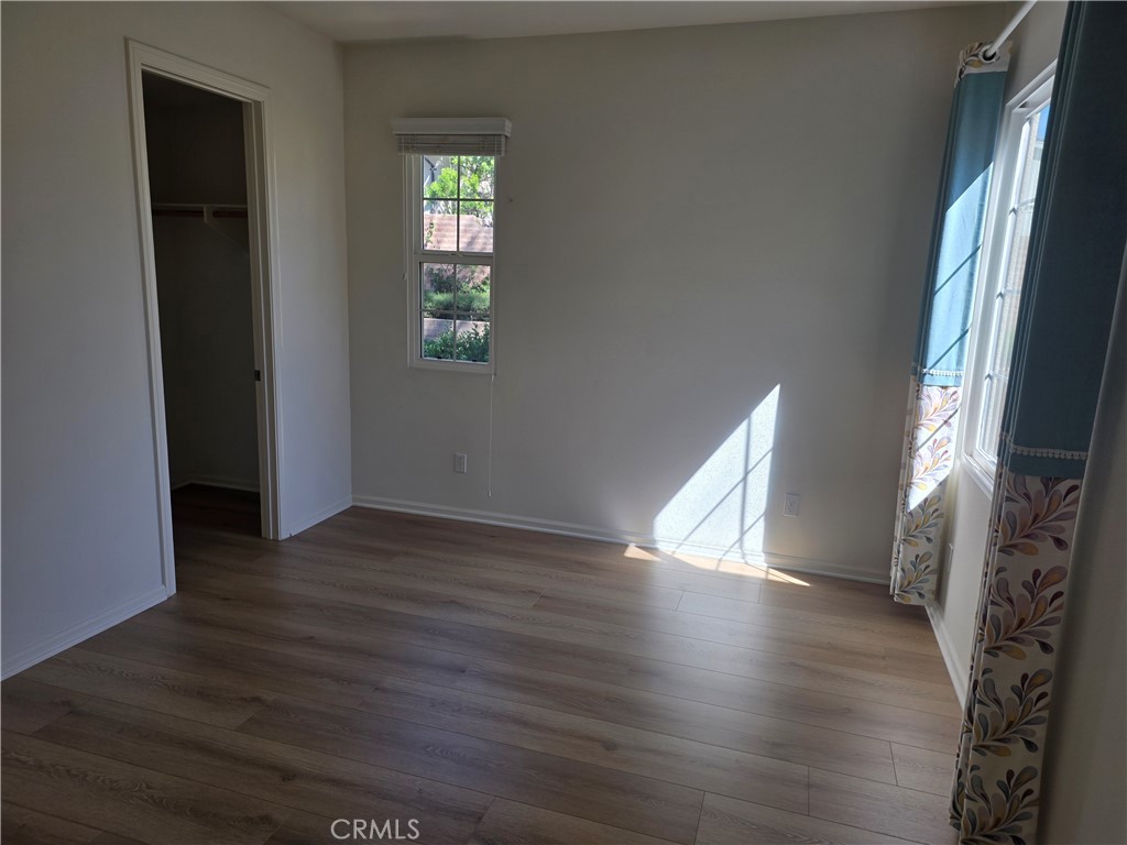 116 Firefly Irvine, CA 92618 - Photo 11 of 16 a view of an empty room with wooden floor and a window