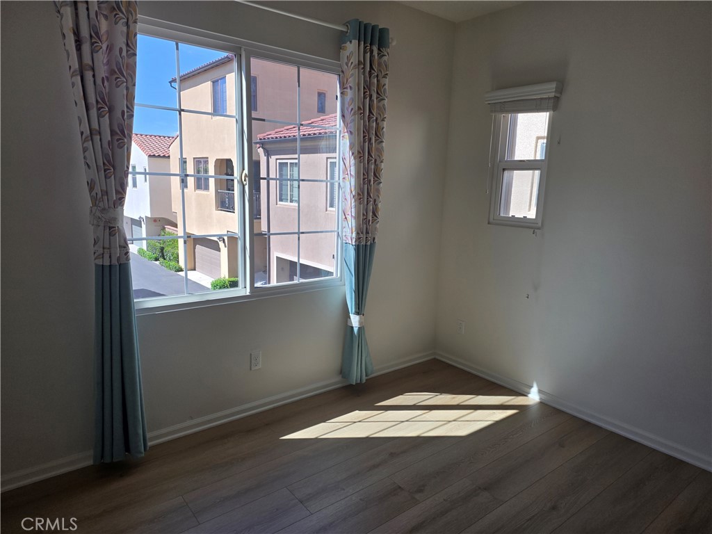 116 Firefly Irvine, CA 92618 - Photo 12 of 16 an empty room with wooden floor and windows