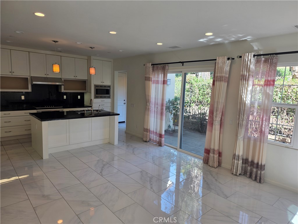 116 Firefly Irvine, CA 92618 - Photo 5 of 16 a kitchen with stainless steel appliances granite countertop a refrigerator and a stove top oven