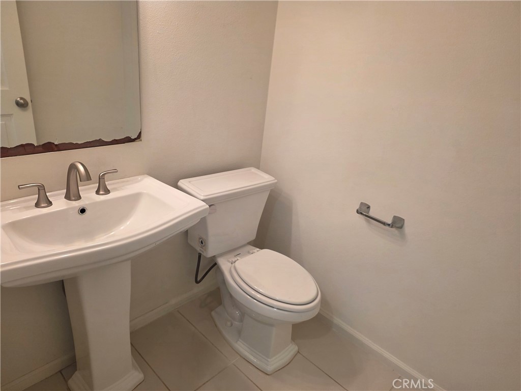116 Firefly Irvine, CA 92618 - Photo 7 of 16 a white toilet sitting next to a bathroom sink
