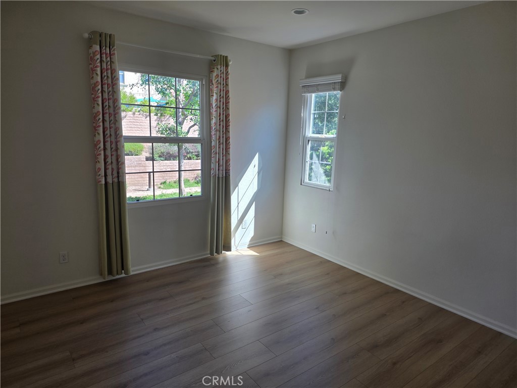 116 Firefly Irvine, CA 92618 - Photo 8 of 16 a view of an empty room with wooden floor and a window