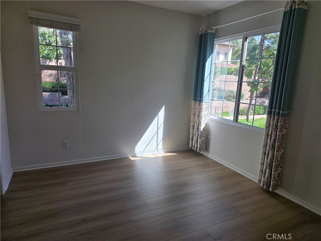 116 Firefly Irvine, CA 92618 - Photo 10 of 16 an empty room with wooden floor and windows