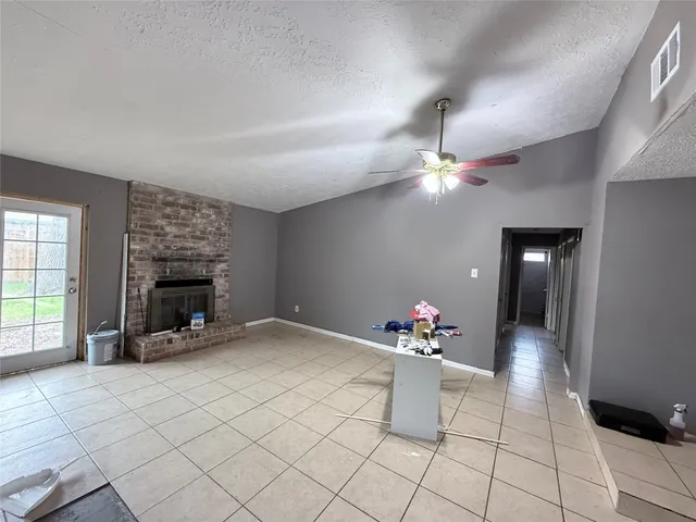 a living room with furniture a fireplace and chandelier