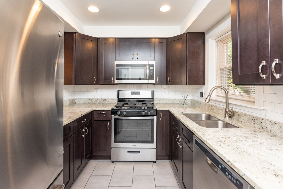 2745 West Gregory Street, Unit 1 Chicago, IL 60625 - Photo 2 of 14 a kitchen with stainless steel appliances granite countertop a sink stove and refrigerator