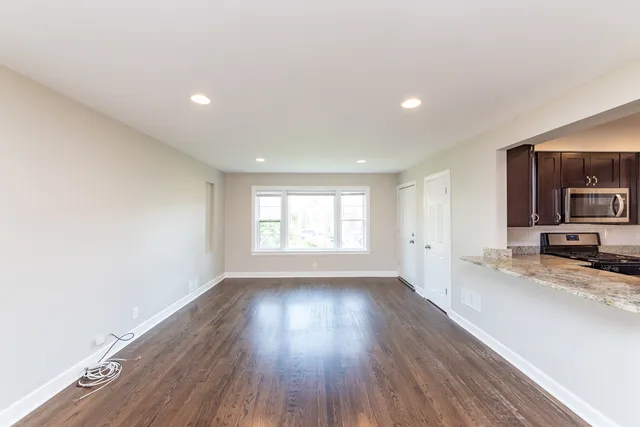 a view of a kitchen and wooden floor