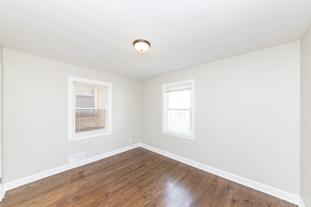 2745 West Gregory Street, Unit 1 Chicago, IL 60625 - Photo 8 of 14 an empty room with wooden floor and windows