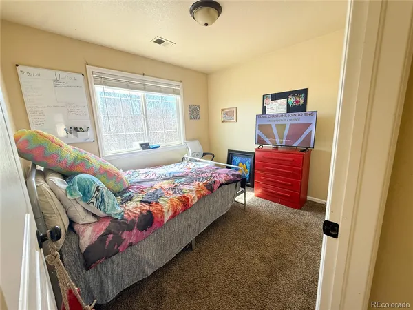 a bedroom with a bed and window