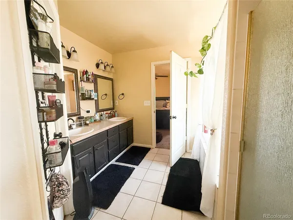 a bathroom with a sink a toilet a mirror and shower