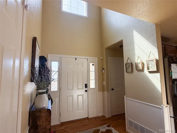 a view of hallway with wooden floor