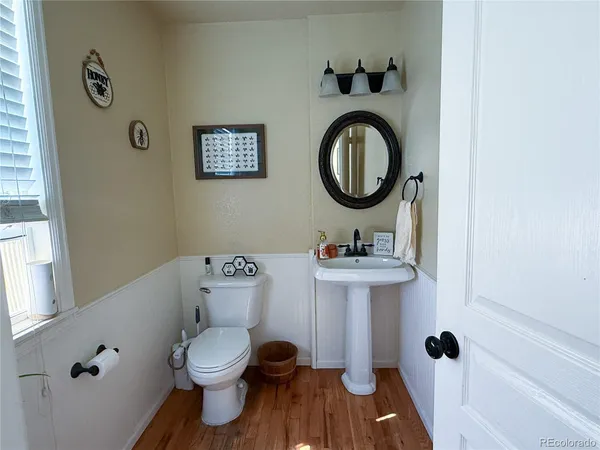 a bathroom with a toilet a sink and a mirror