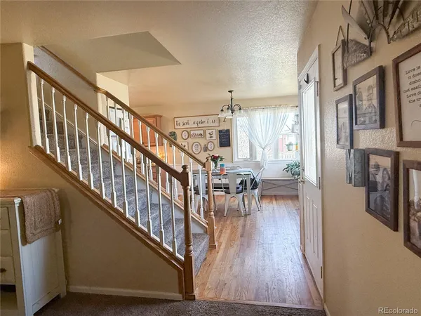 a view of entryway and dining room with wooden floor