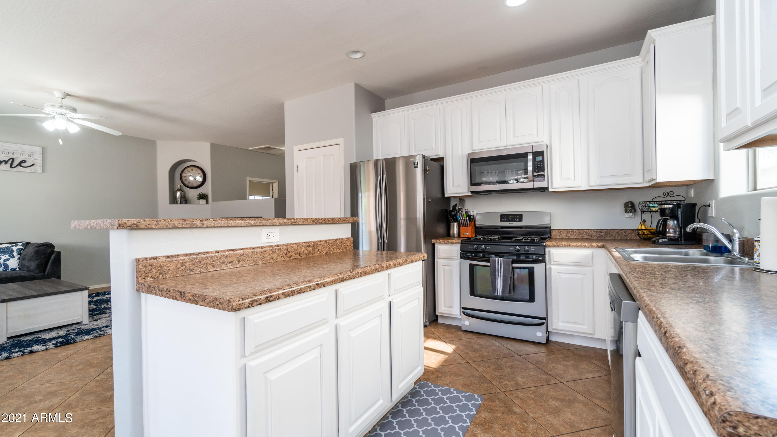 45417 West Zion Road Maricopa, AZ 85139 - Photo 11 of 31 a kitchen with stainless steel appliances granite countertop a sink stove and refrigerator