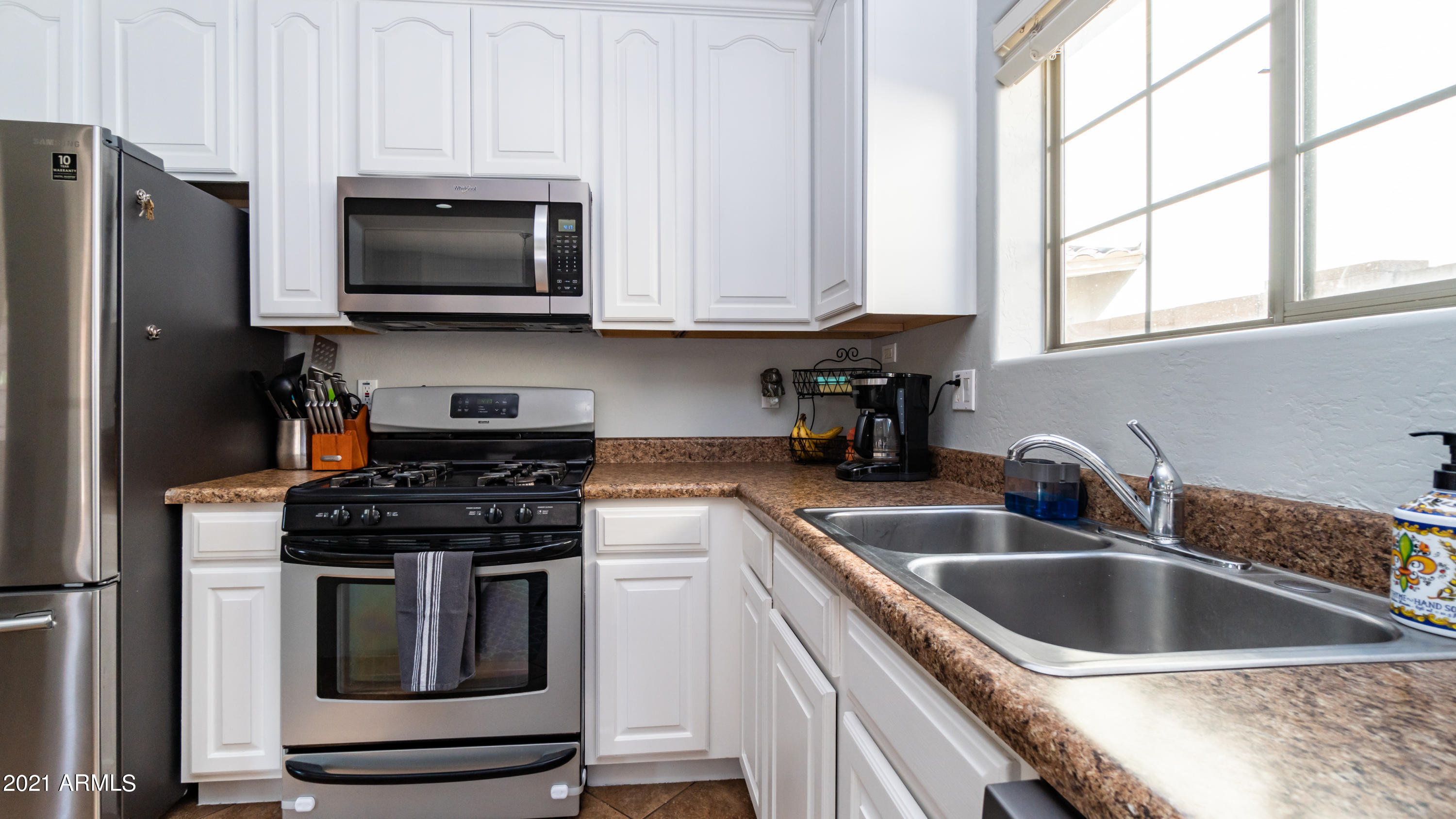 45417 West Zion Road Maricopa, AZ 85139 - Photo 12 of 31 a kitchen with stainless steel appliances granite countertop a sink stove and microwave