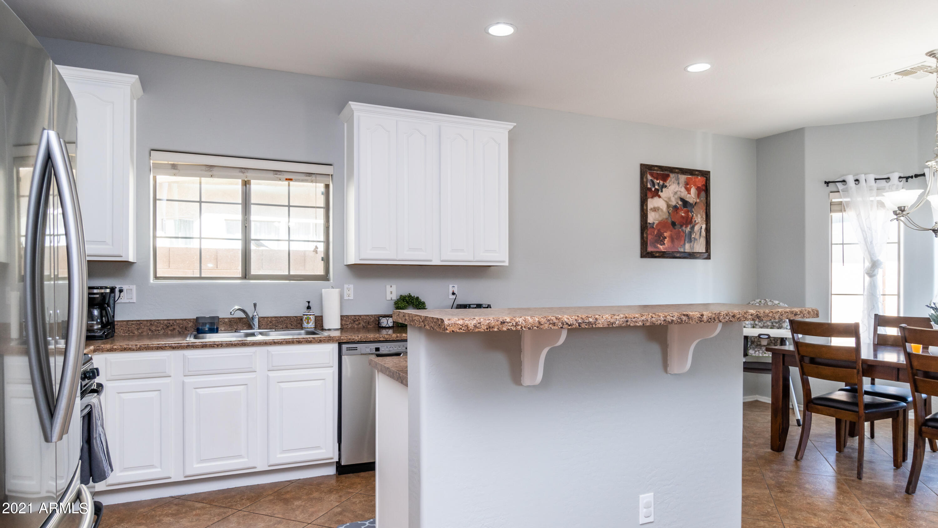 45417 West Zion Road Maricopa, AZ 85139 - Photo 13 of 31 a kitchen with a sink cabinets and window