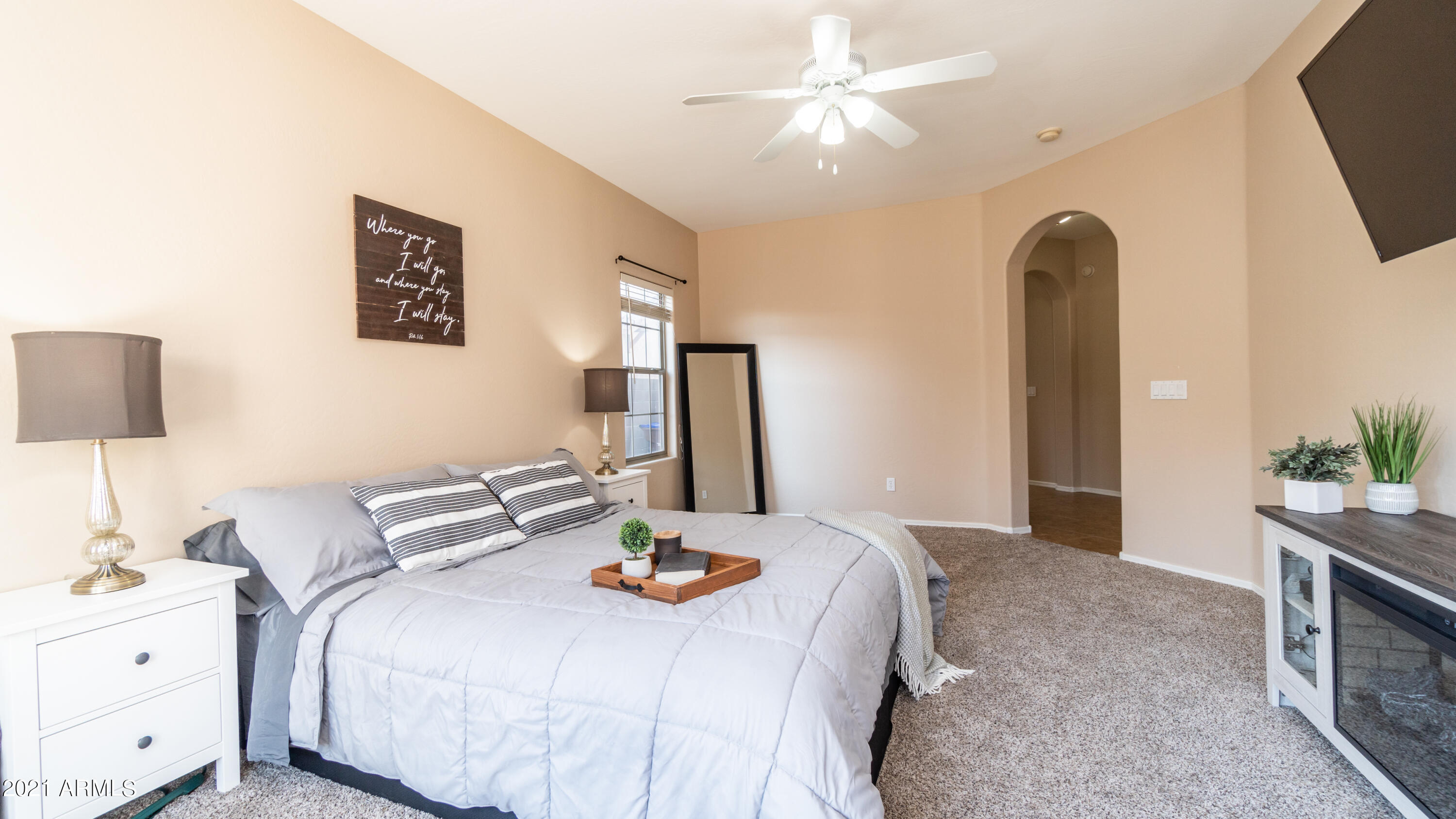 45417 West Zion Road Maricopa, AZ 85139 - Photo 19 of 31 a bedroom with a bed and a chandelier