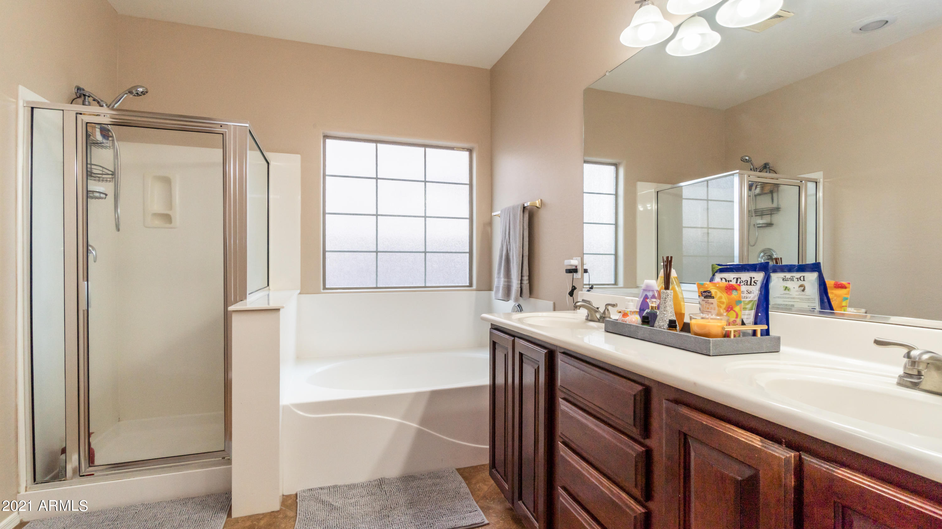45417 West Zion Road Maricopa, AZ 85139 - Photo 21 of 31 a bathroom with a tub sink and mirror