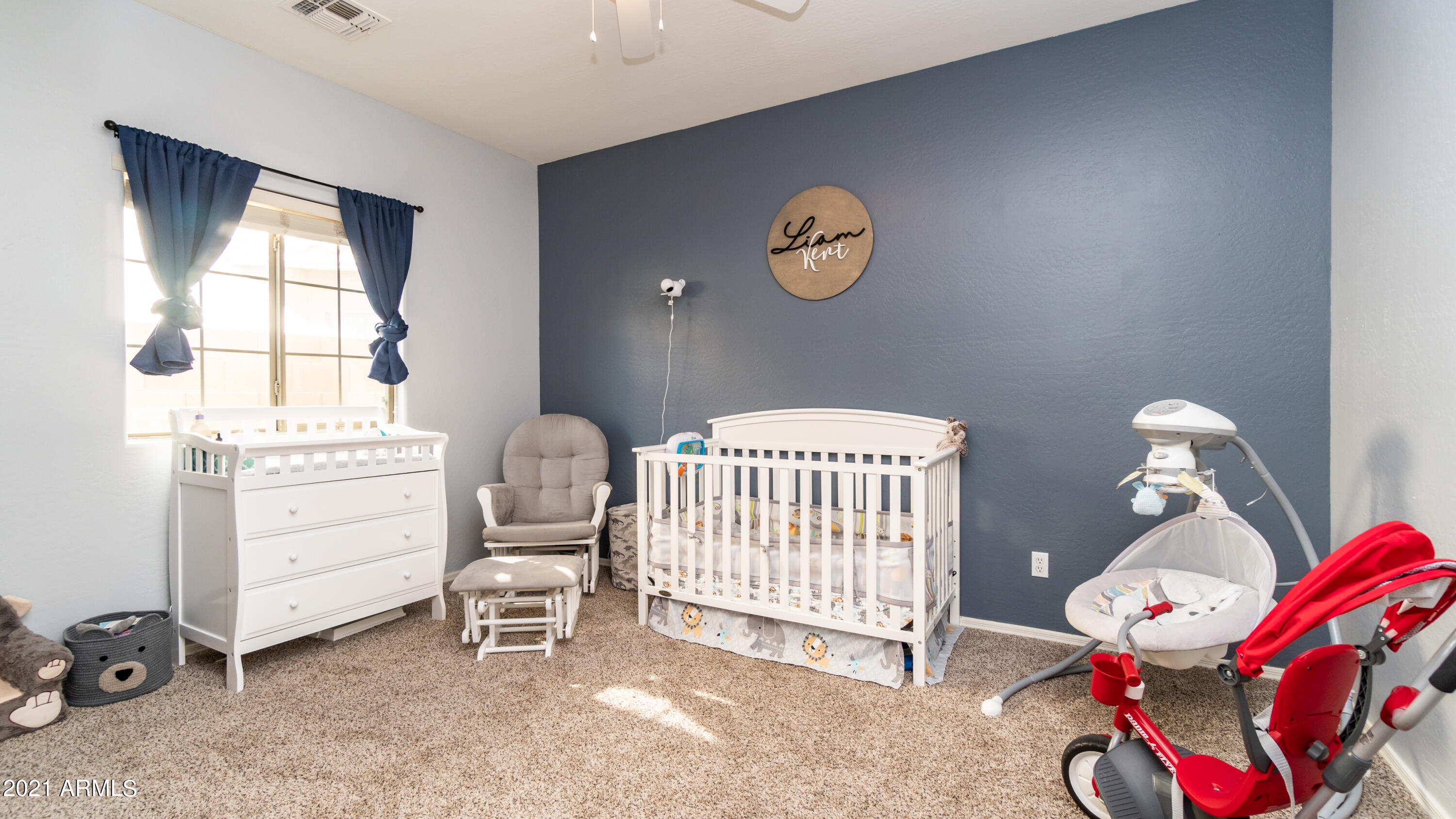 45417 West Zion Road Maricopa, AZ 85139 - Photo 24 of 31 a bedroom with a baby bed a chandelier and a window