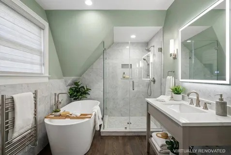 a spacious bathroom with a bathtub shower sink and mirror