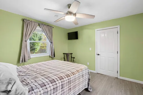 a bedroom with a bed and a window