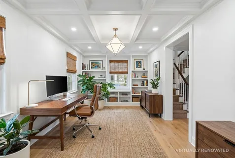 a view of a livingroom with furniture and a workspace