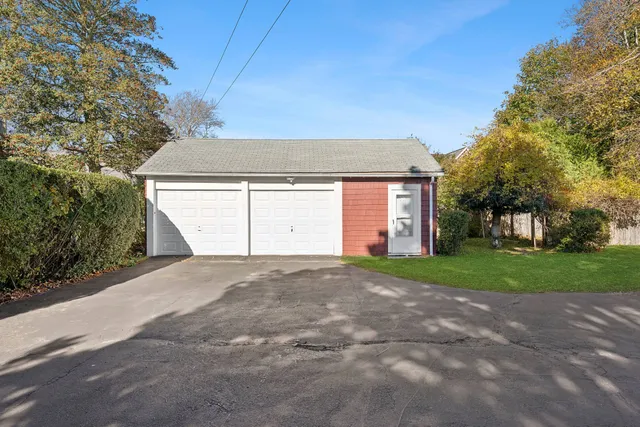 a view of a house with a yard and garage
