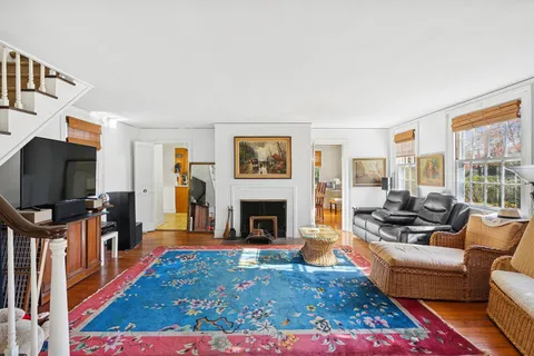 a living room with furniture a flat screen tv and a fireplace