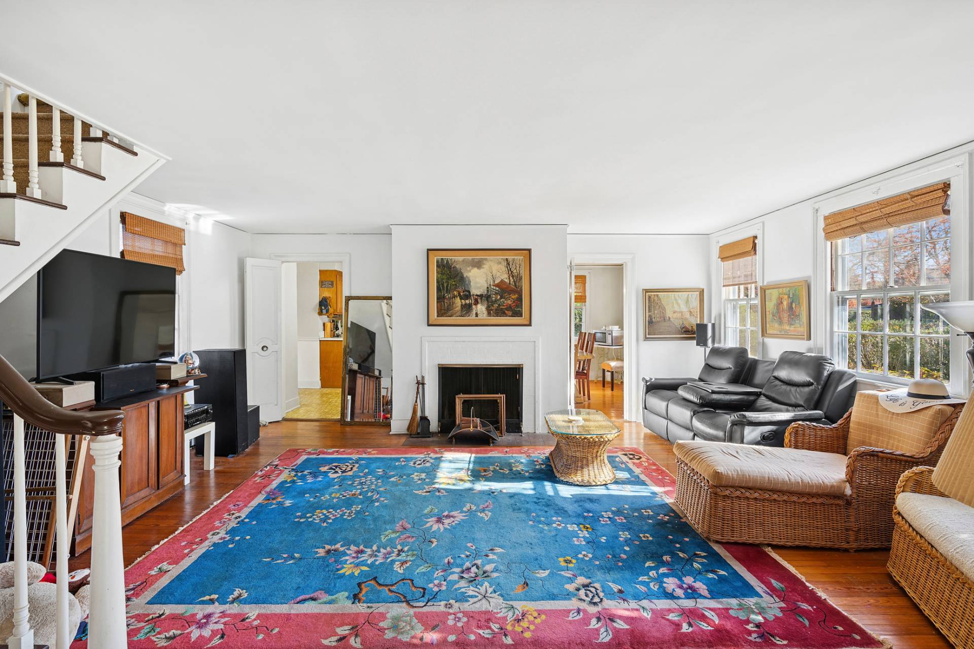 201 Herrick Road Southampton, NY 11968 - Photo 4 of 29 a living room with furniture a flat screen tv and a fireplace