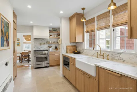 a kitchen with stainless steel appliances a stove sink and cabinets