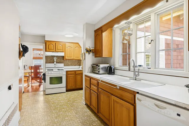 a kitchen with stainless steel appliances a stove sink and cabinets