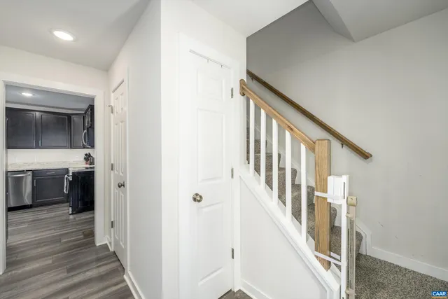 a view of an entryway with wooden floor and a sink