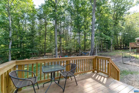 a view of a chair and tables on the deck