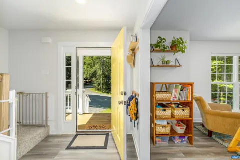 a living room with furniture and a floor to ceiling window