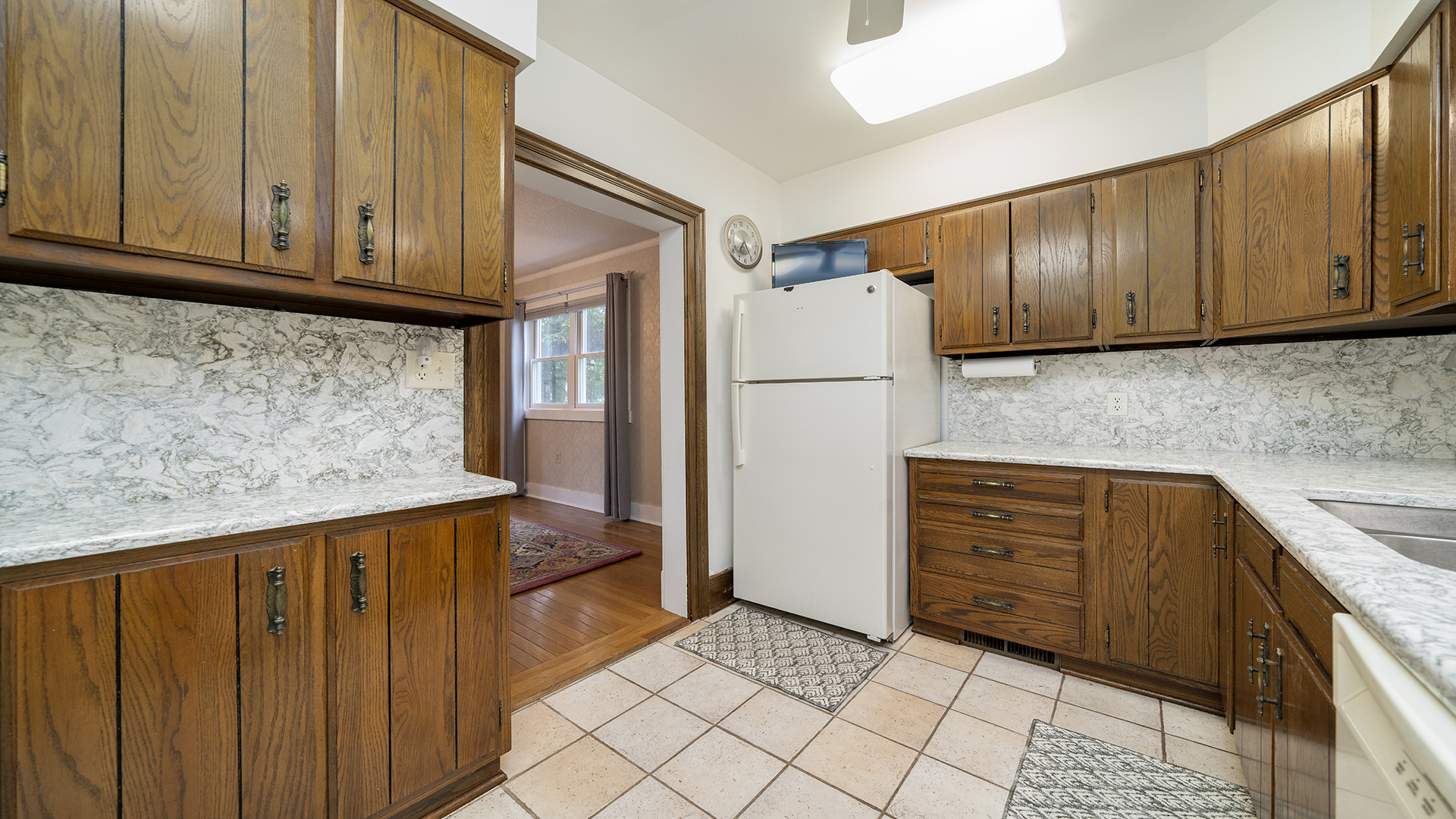 321 East Chamberlin Street Dixon, IL 61021 - Photo 14 of 58 a kitchen with granite countertop wooden cabinets and white appliances