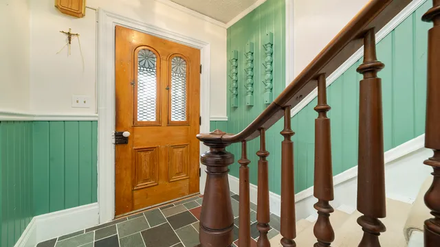 a bedroom with a bed couch and windows