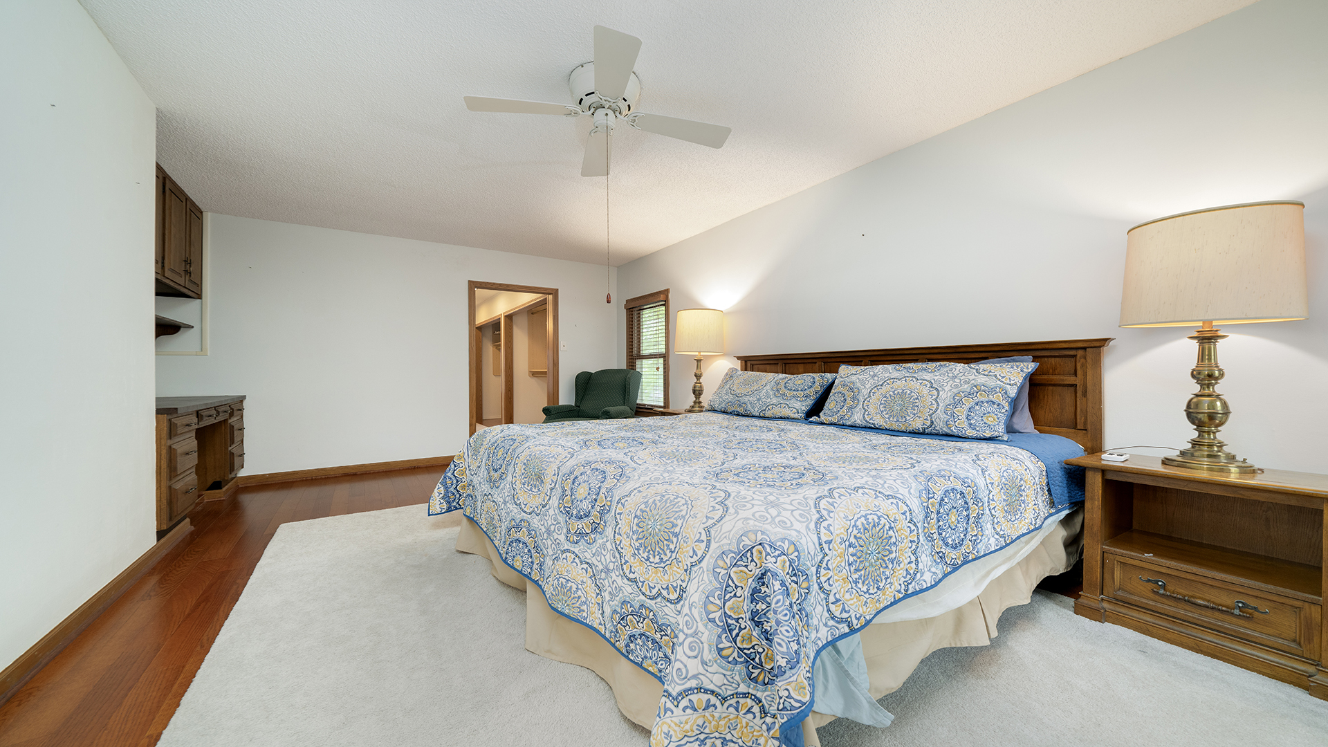 321 East Chamberlin Street Dixon, IL 61021 - Photo 27 of 58 a spacious bedroom with a bed and a lamp