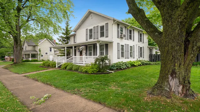 a front view of a house with a garden