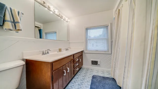 a front view of a house with yard and green space