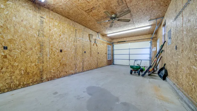 an aerial view of a house with a yard potted plants and large tree
