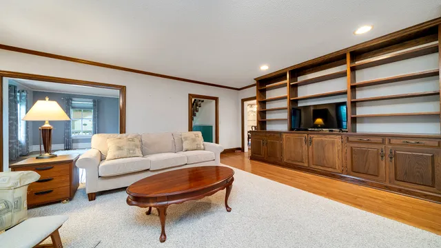 a living room with furniture fireplace and flat screen tv