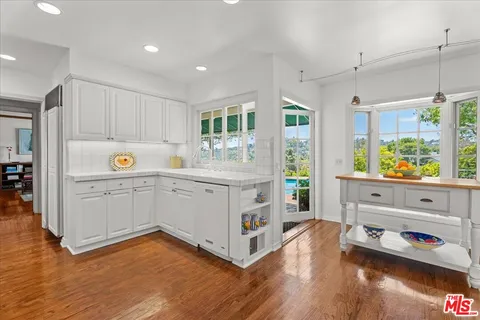 a kitchen with a cabinets and wooden floor