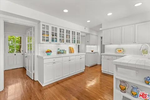 a kitchen with wooden cabinets and center island