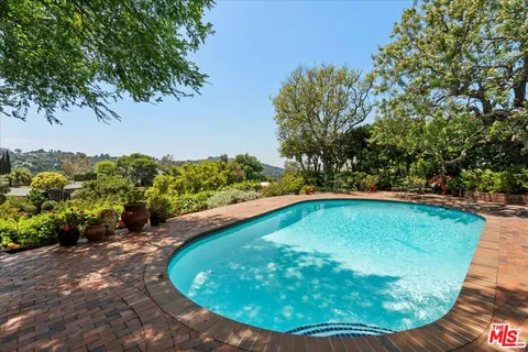 a view of a swimming pool with a yard