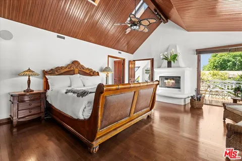 a bedroom with furniture and large windows