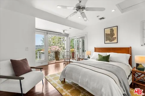 a bedroom with a bed and glass window