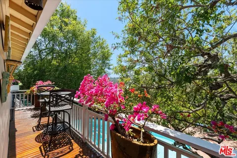 a view of a patio with table and chairs and wooden floor